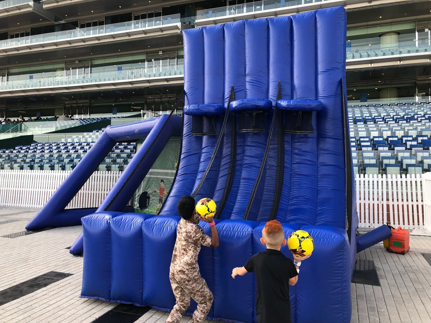 Two children seen from behind at an inflatable slide.