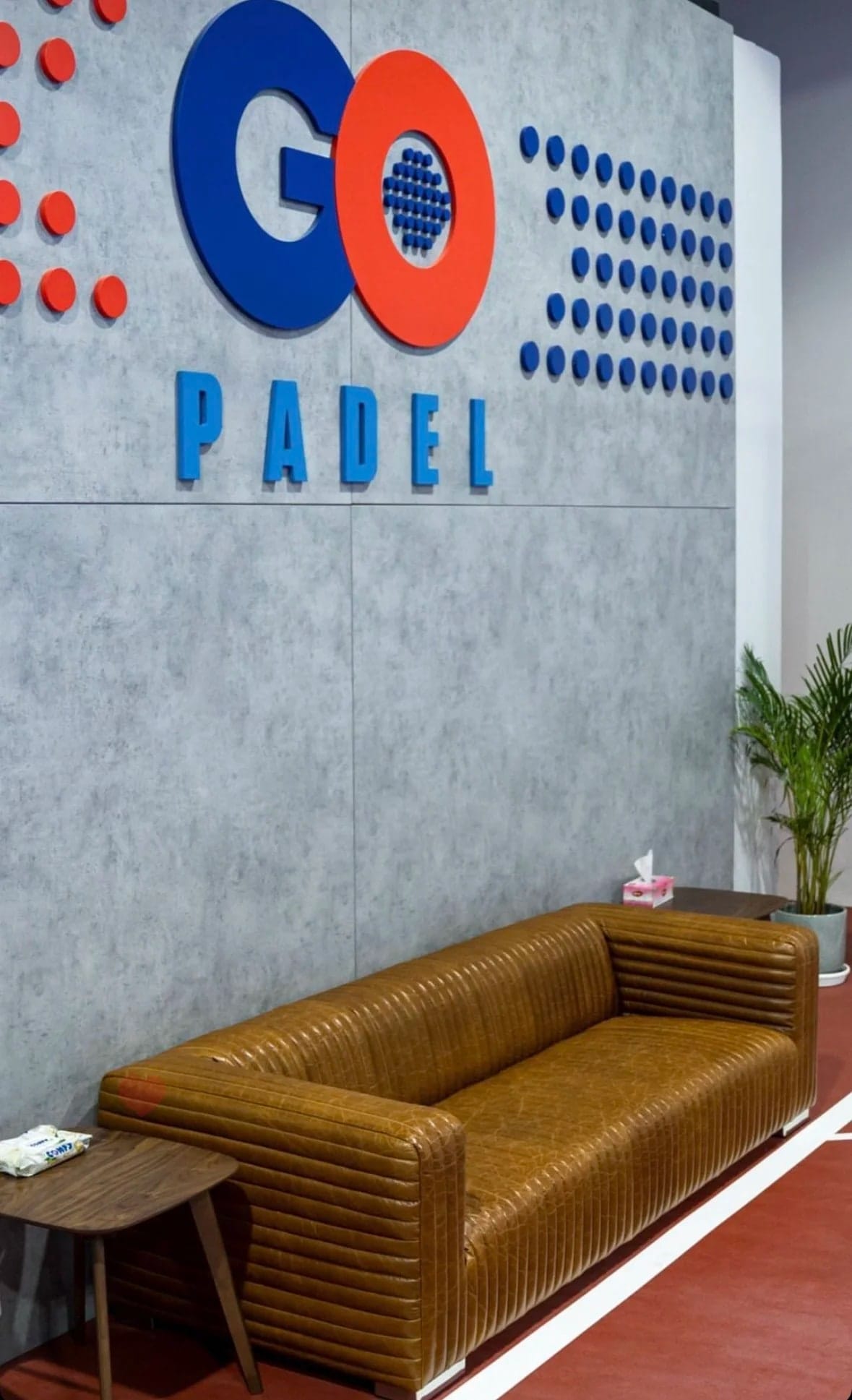 The lounge and logo wall at Go Padel Ajman.